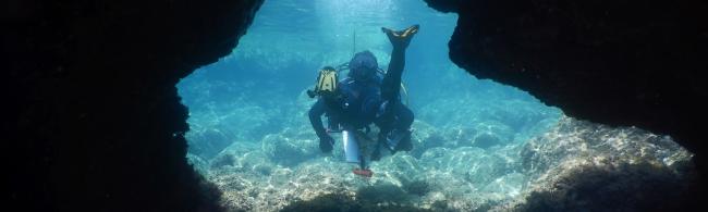 a diver in a rock passage underwater