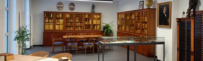 Lesesaal mit alten Bücherschränken, Vitrinen, Tischen und Stühlen