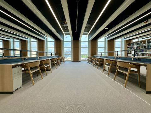 View of the reading room with shelves and workstations