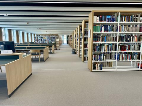 View of the reading room with shelves and workstations
