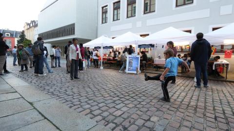 Ein Junge kickt einen chinesischen Federball (Jianzi)