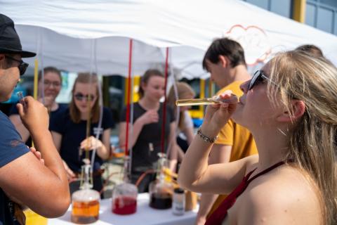 Studierende veteilen Getränke in Reagenzgläsern