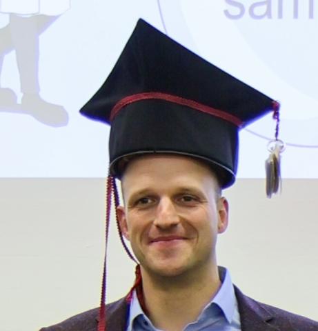 Dr. Felix Spiske mit Doktorhut nach der Verteidigung seiner Dissertation