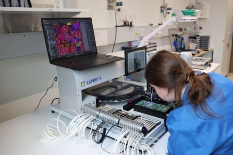 Ein Studierender bestückt die PCB mit elektronischen Bauteilen unter Verwendung eines halbautomatischen Bestückungsautomaten.