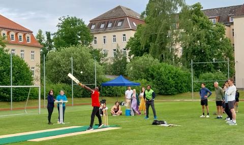 Impression von der Cricket-Challenge: Ein Sportler mit erhobenem Cricketschläger