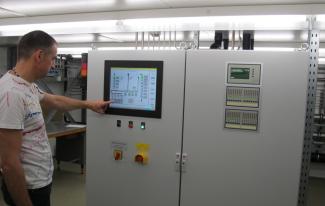 Employee operates the touchscreen of the gas control system