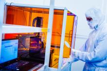 Employee inserts a wafer into the nano-plotter